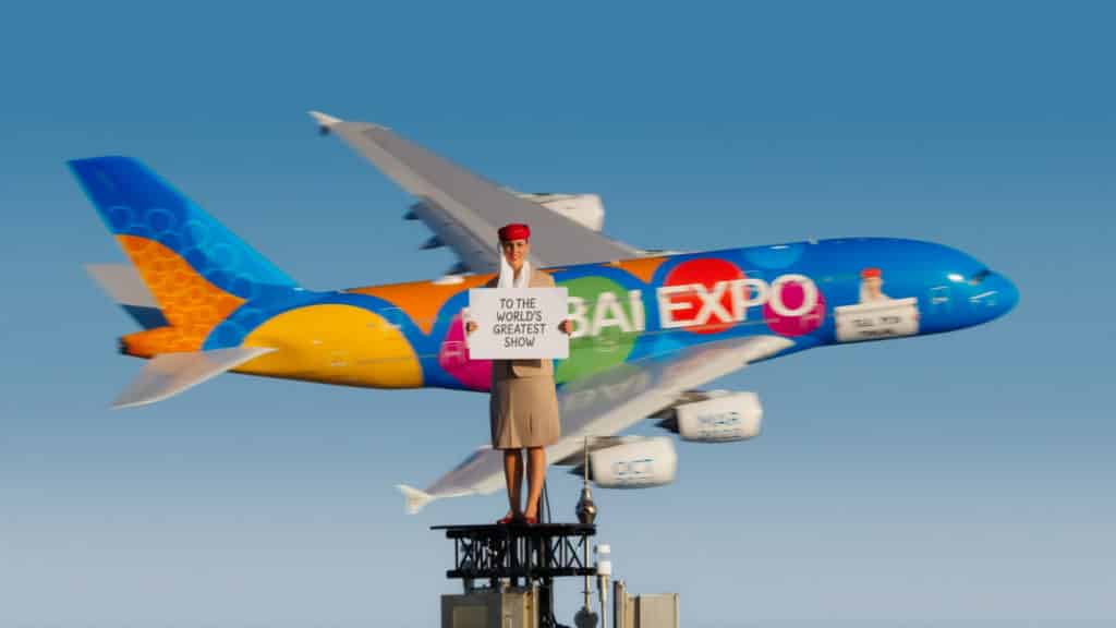 Emirates Stewardess auf dem Burj Khalifa mit Flugzeug A380 im Hintergrund